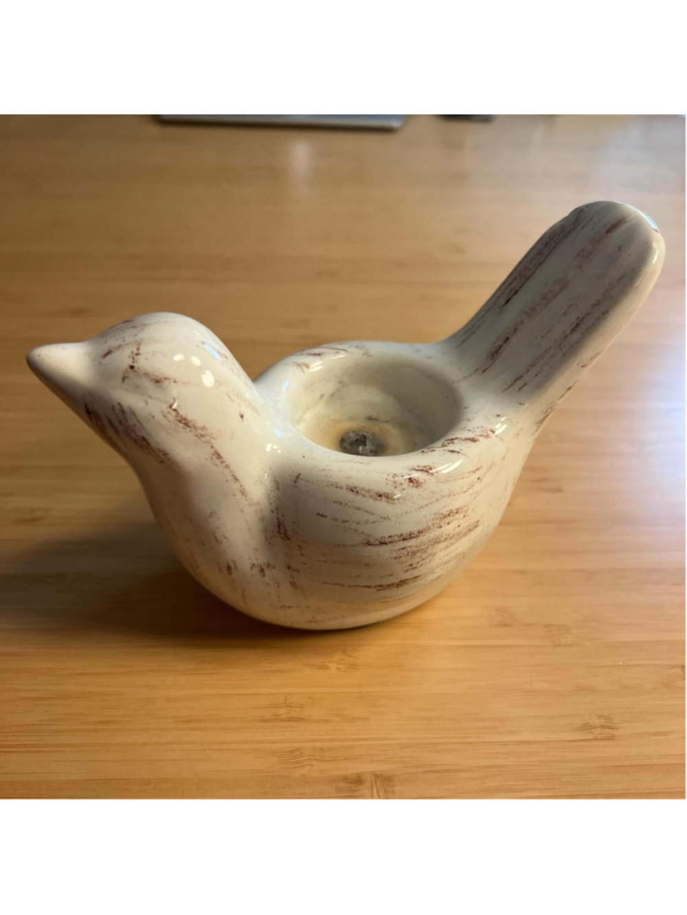 White ceramic bird-shaped candle holder
